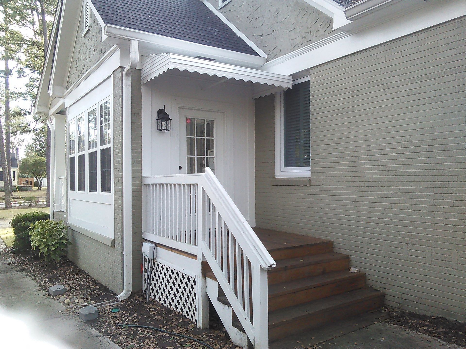 White aluminum awning installed over side door