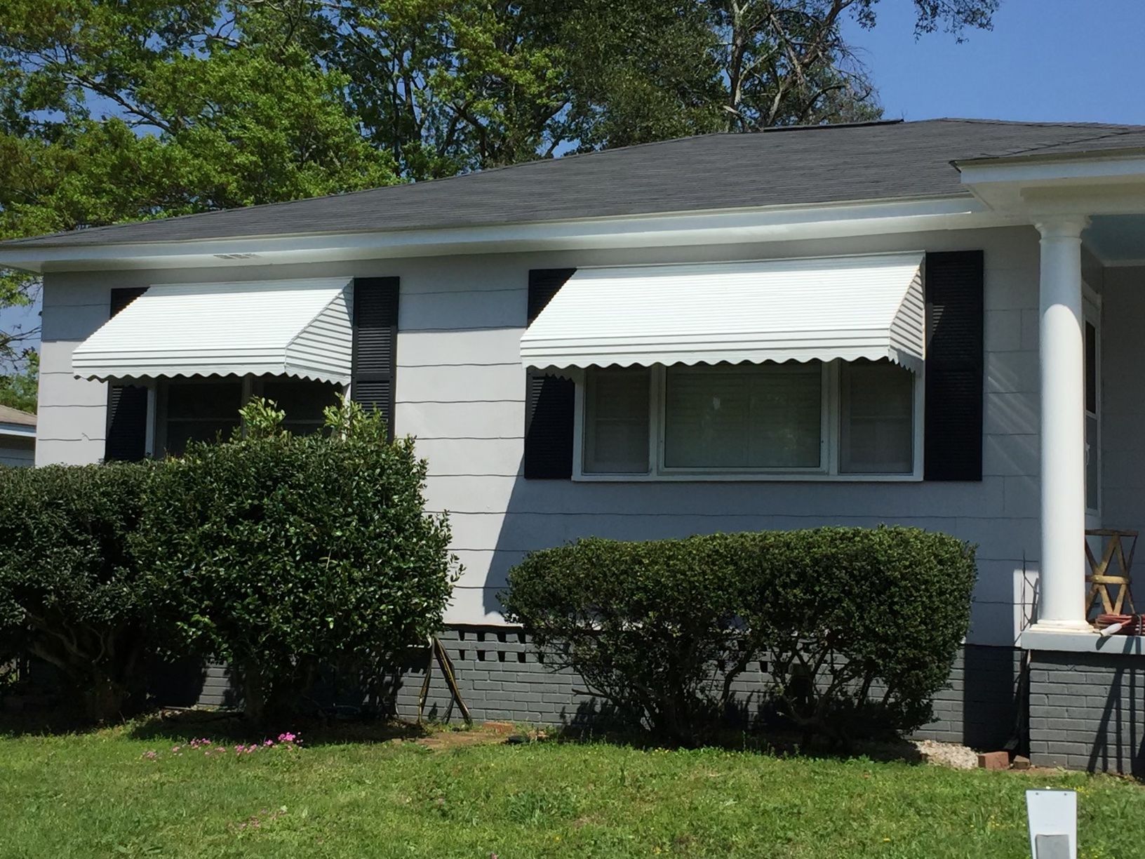 white step down aluminum awnings with fringe on windows