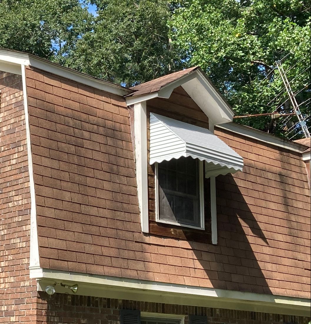 White step down aluminum awning installed on window