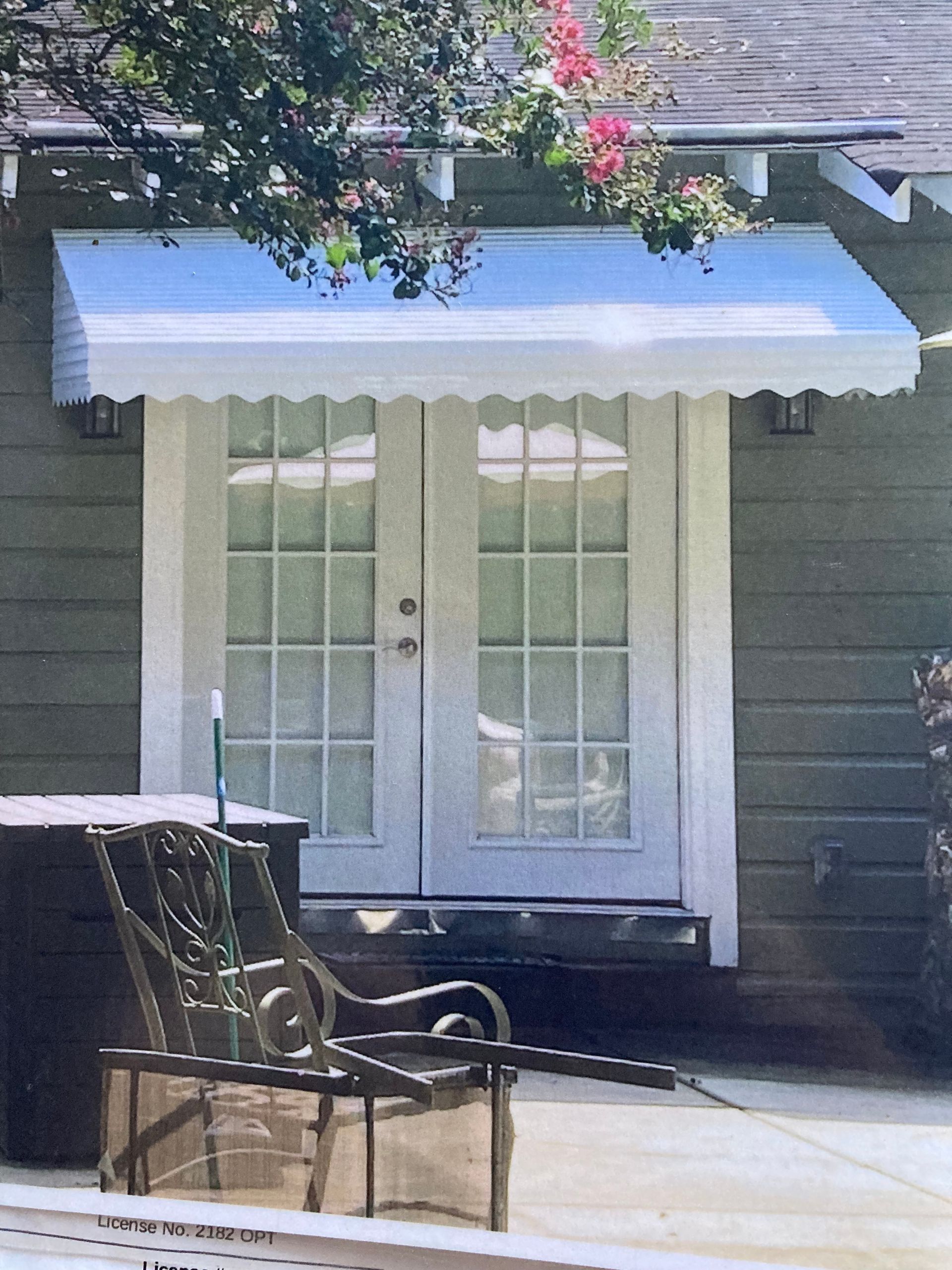 Step down aluminum awning installed over double doors