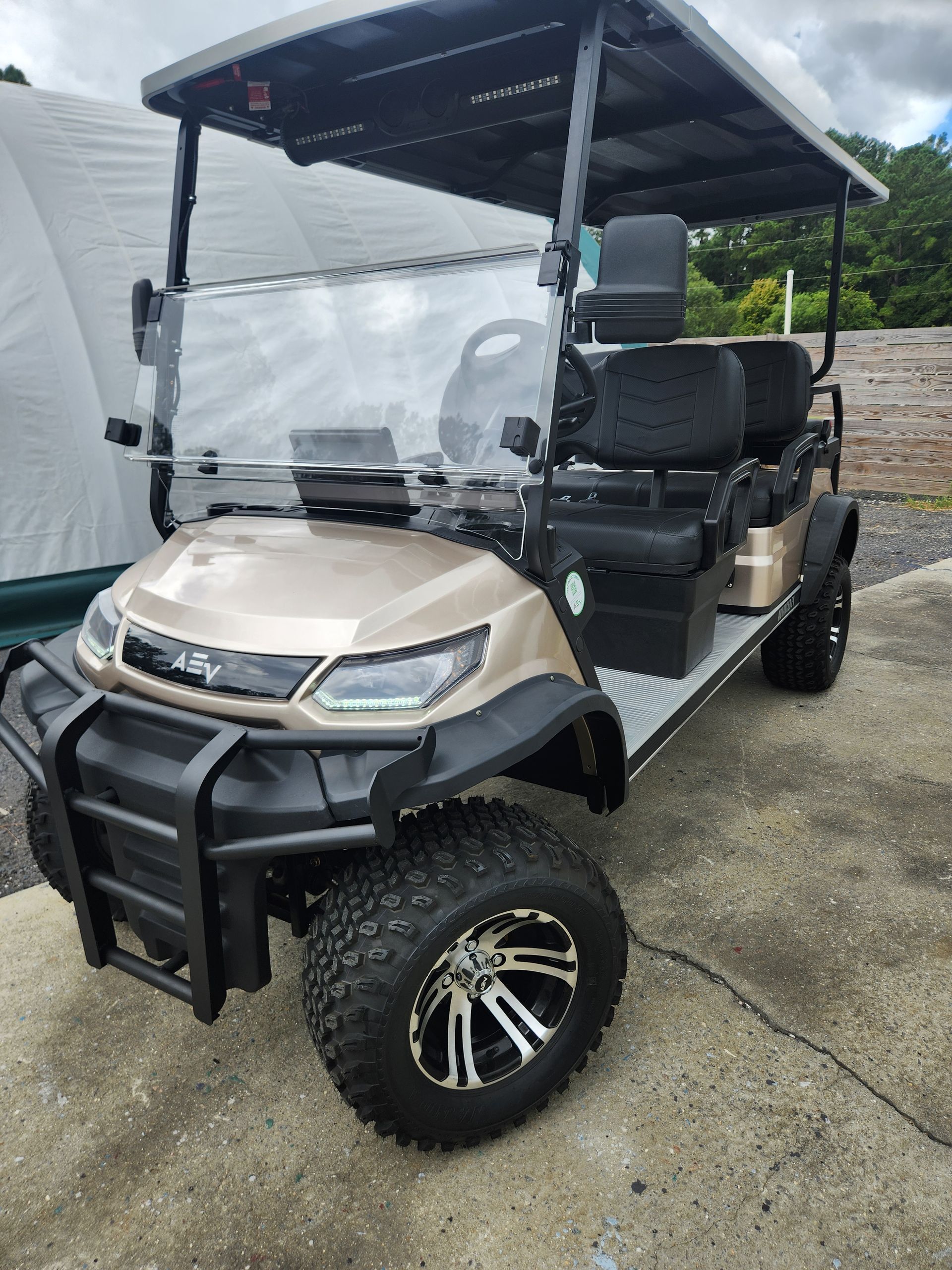 A golf cart is parked on the side of the road.