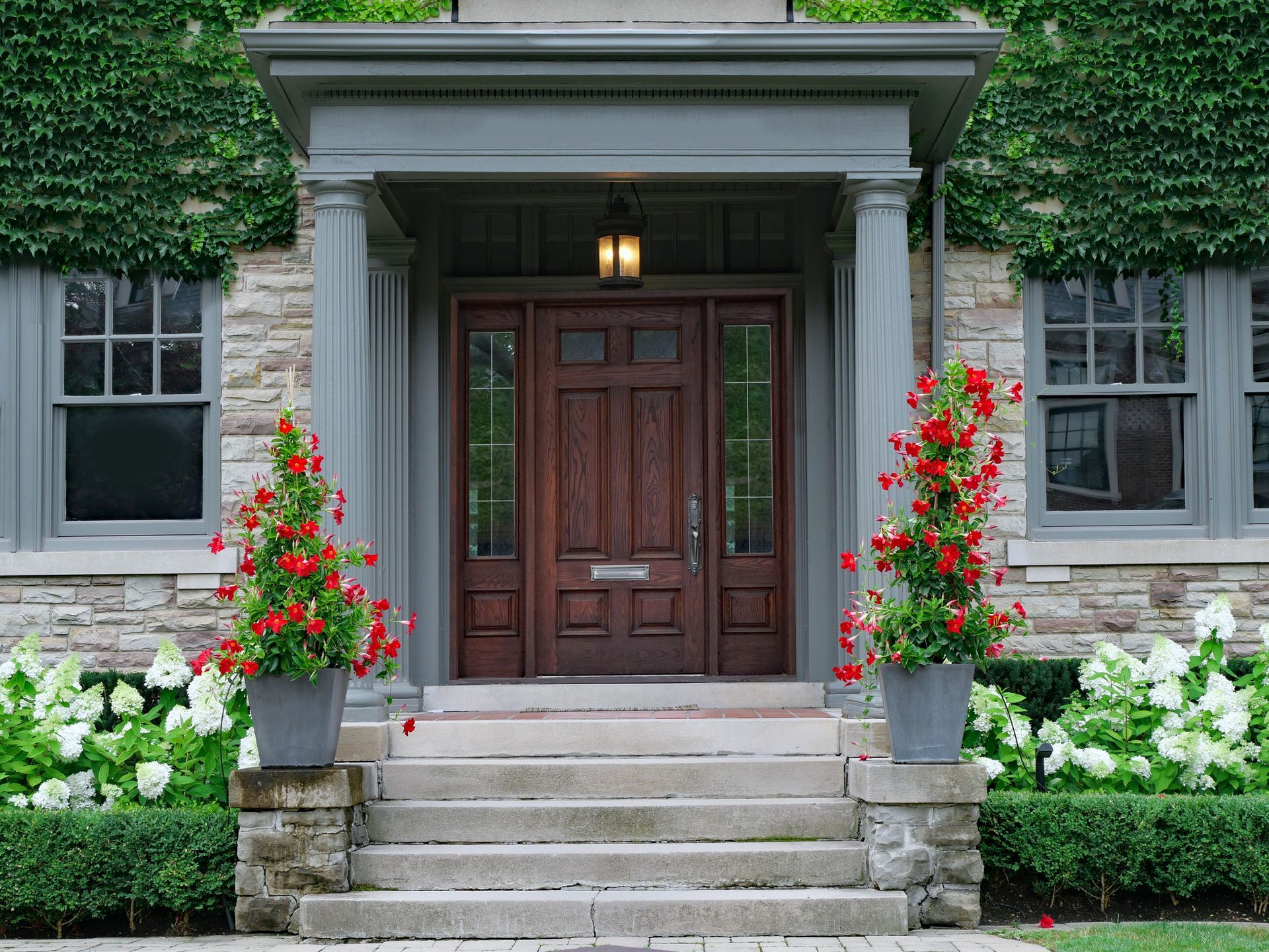 Stylish wood grain door with matching sidelights enhancing the curb appeal of a modern home. Stylish wood grain door with matching sidelights enhancing the curb appeal of a modern home.