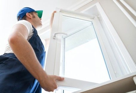 A person installing a window
