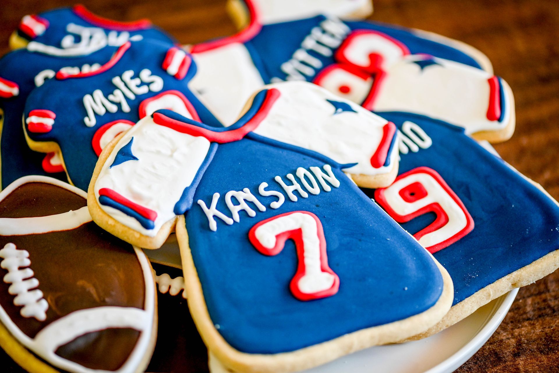a plate of cookies decorated to look like football jerseys