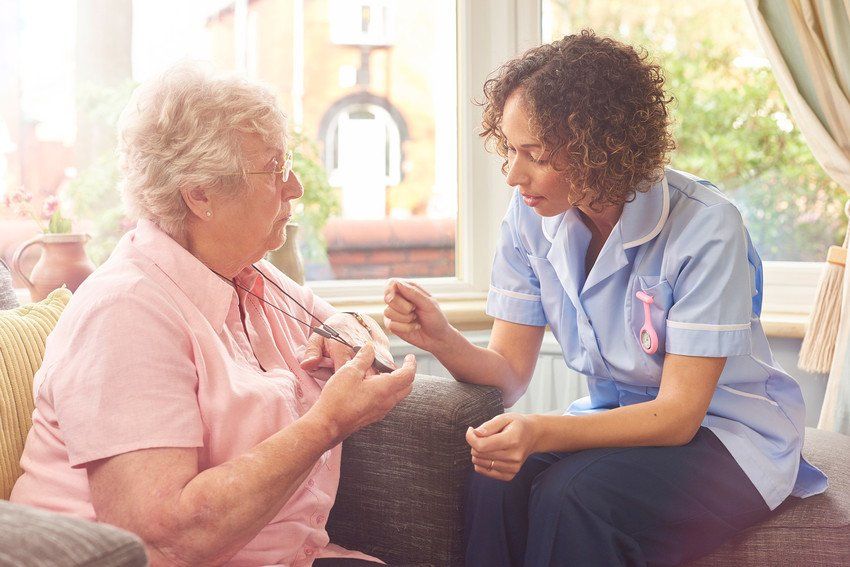 nurse talking to old woman