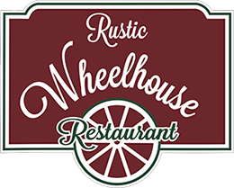 A sign for rustic wheelhouse restaurant with a wheel on it.