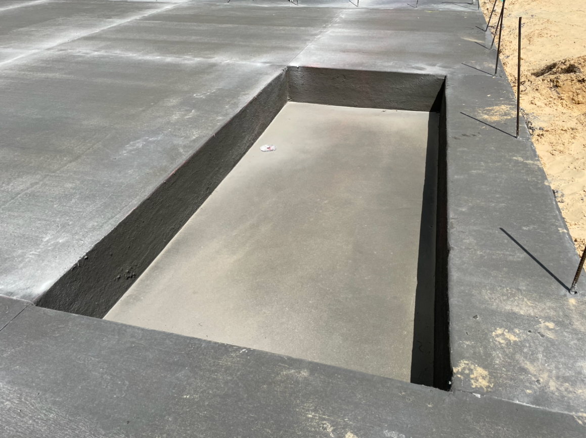 A concrete foundation with a hole in the middle of it.