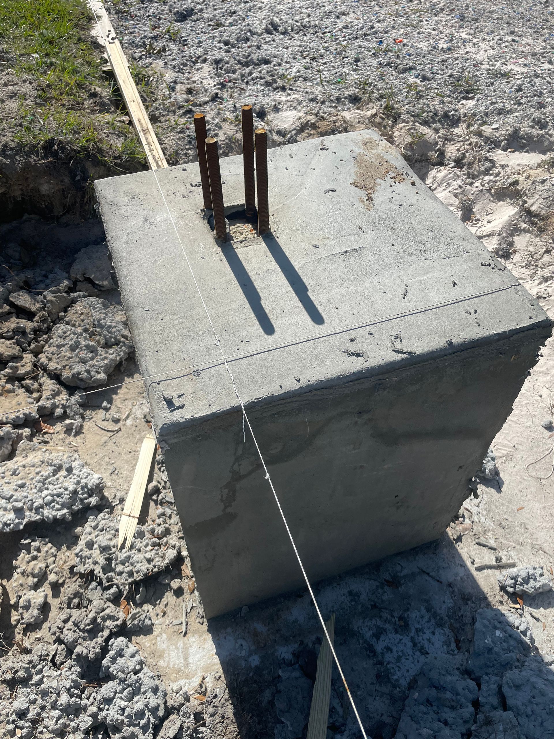 A concrete block is sitting on top of a dirt ground