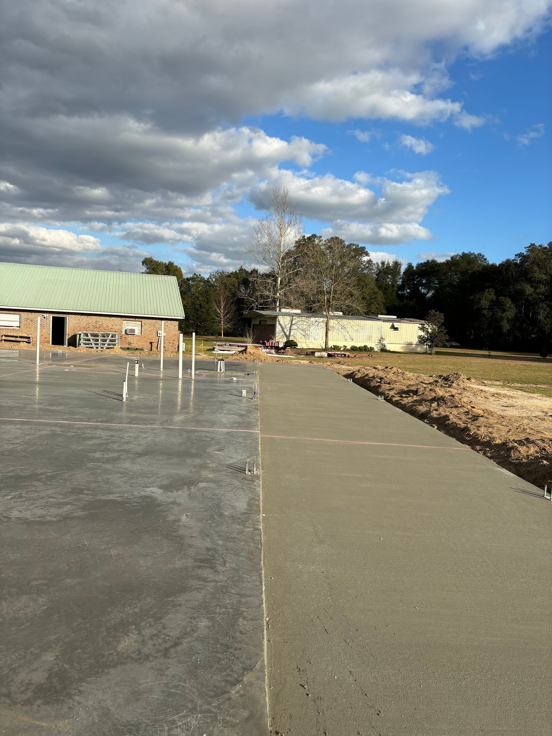 A concrete walkway with a building in the background