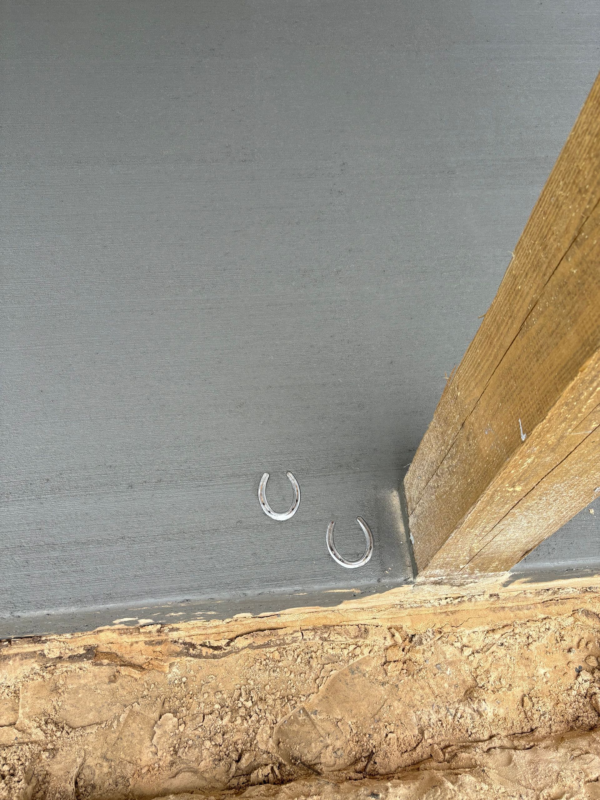 A close up of a wooden post on a concrete floor.