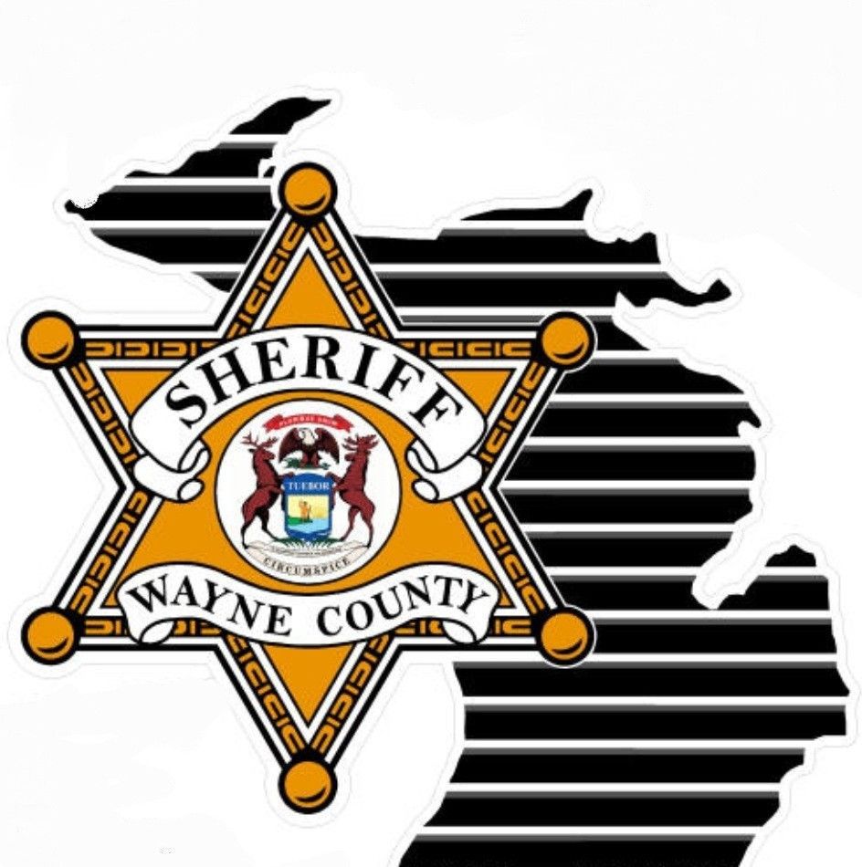A Wayne County sheriff 's badge is on a map of Michigan.