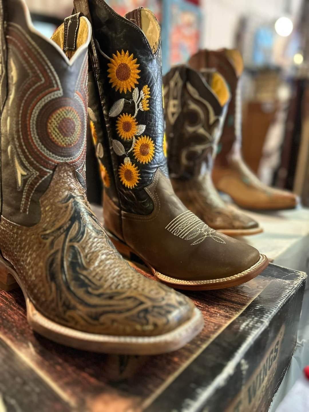 A pair of cowboy boots are sitting on top of a box.