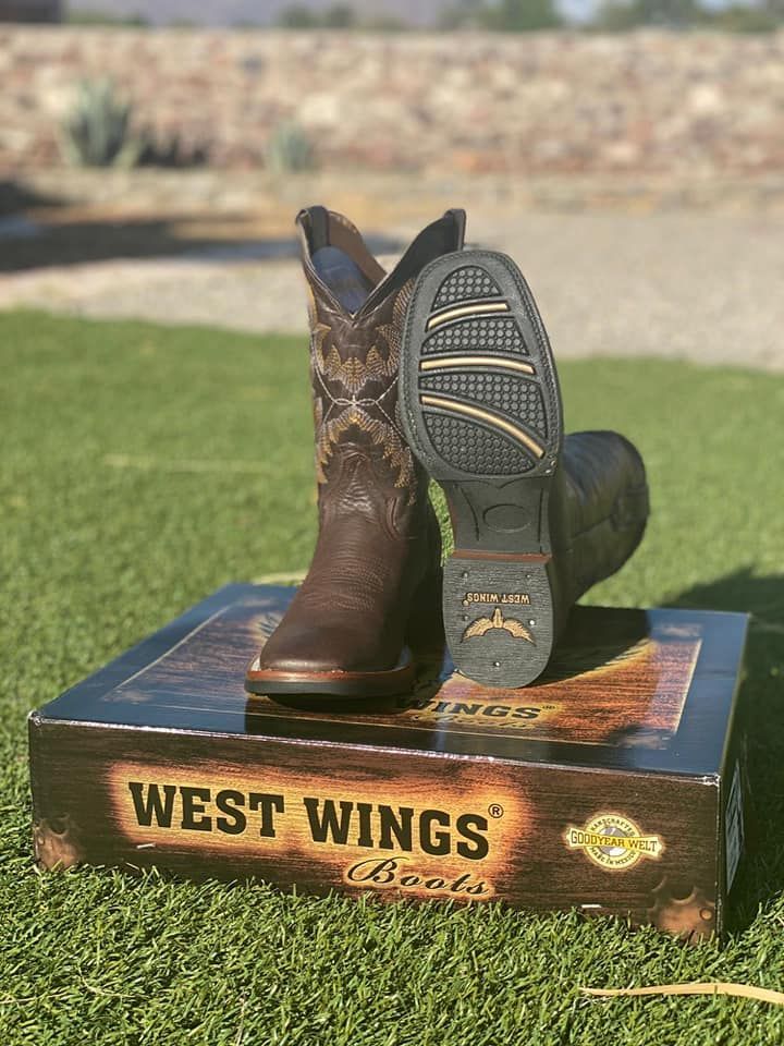 A pair of cowboy boots are sitting on top of a box.