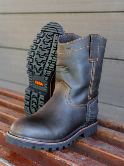 A pair of brown boots sitting on a wooden bench