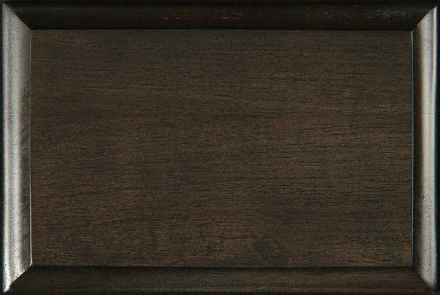 A close up of a piece of wood with a sample stain - charcoal