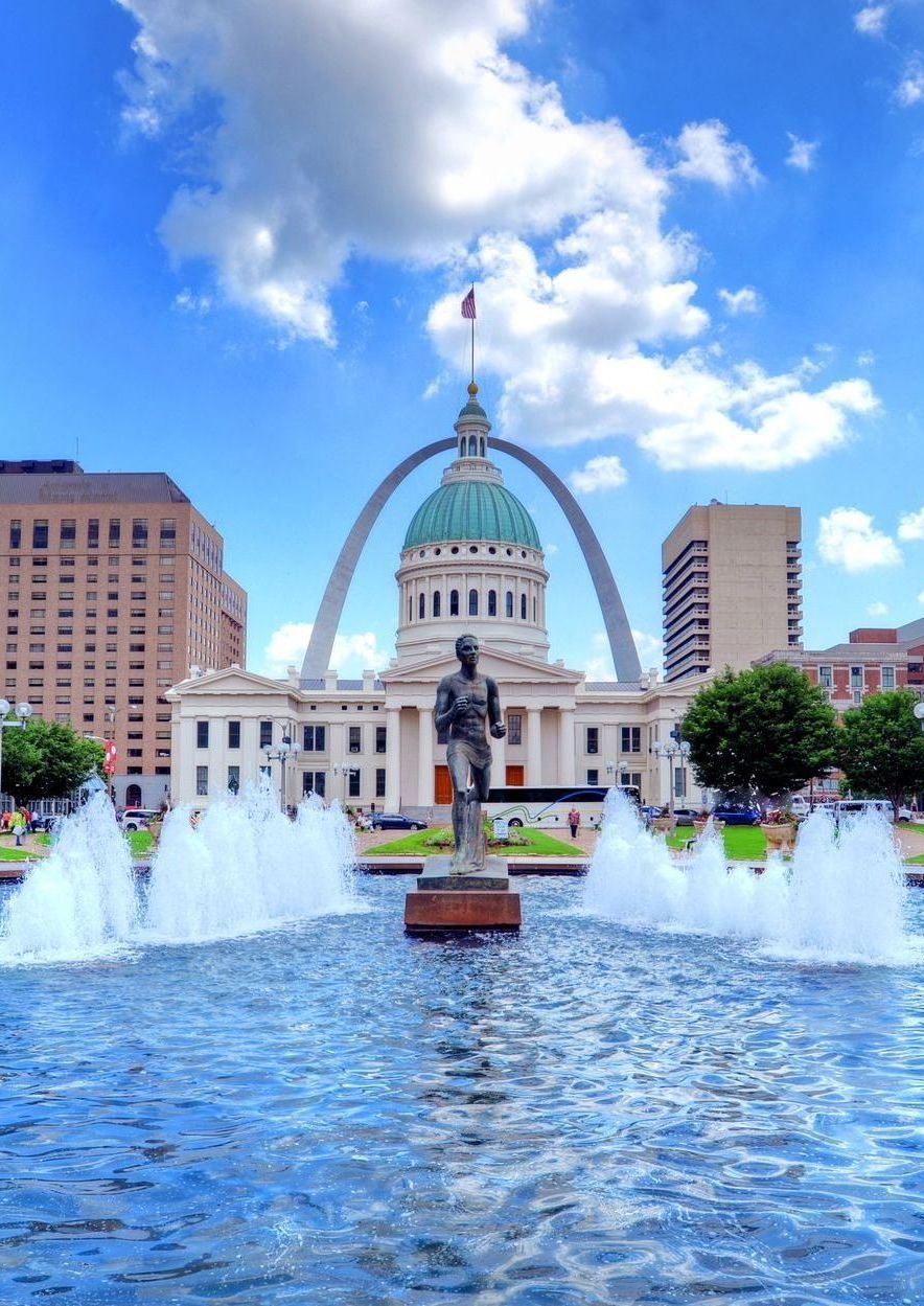 St. Louis Gateway Arch and courthouse dome against blue sky
