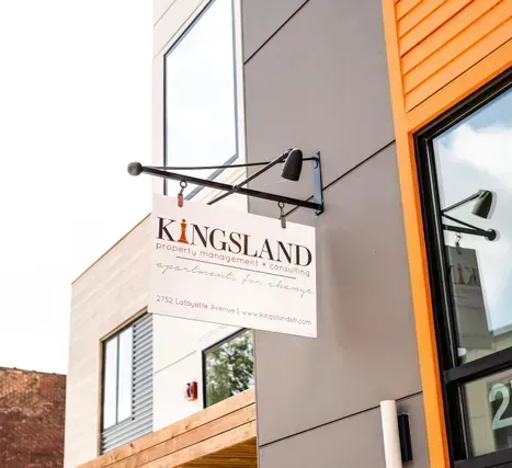 Property entrance with Kingsland sign and orange facade