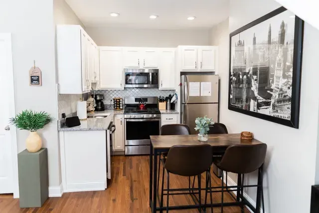 Modern kitchen and dining area in updated apartment unit
