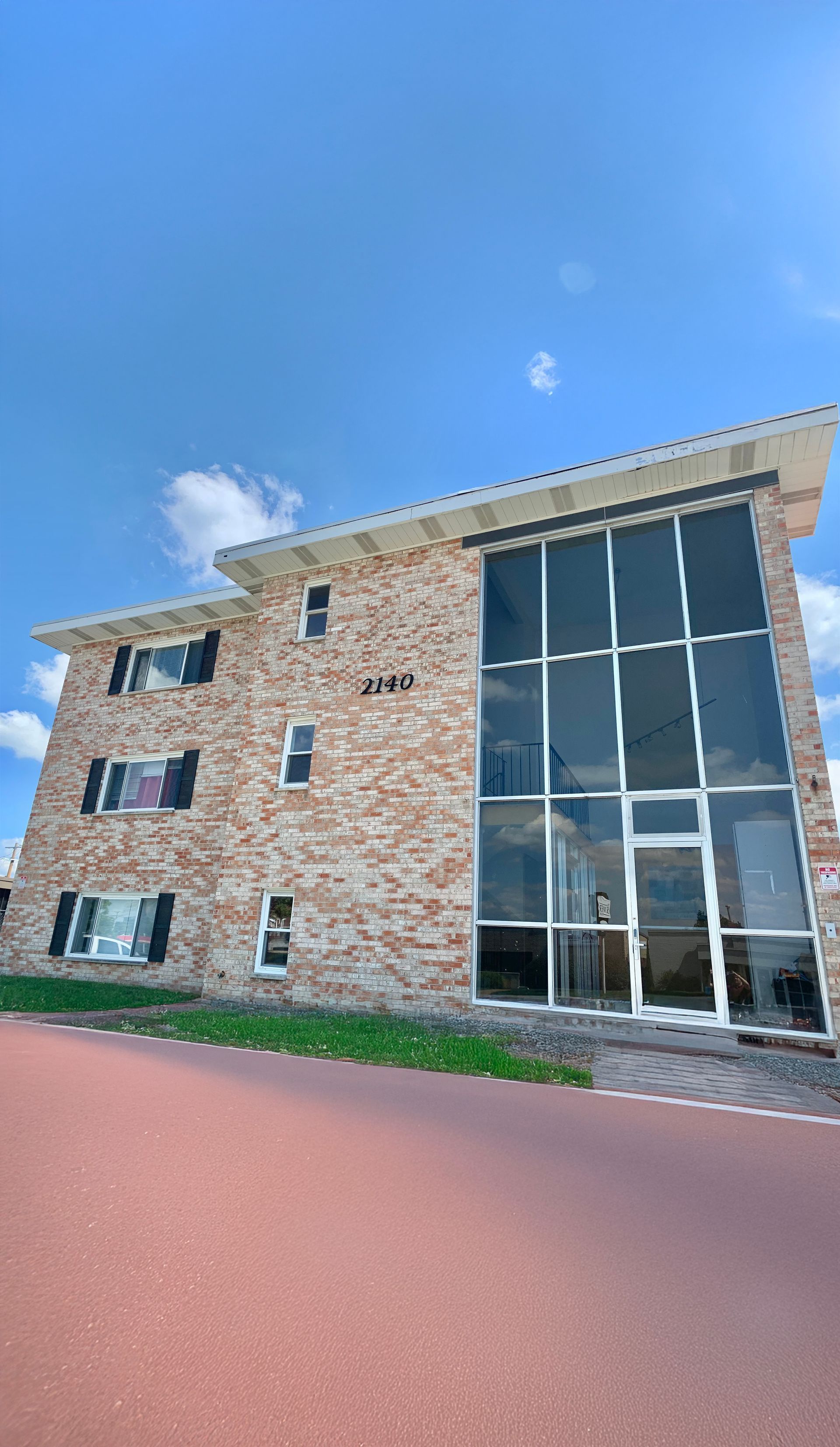 Partial view of building roofline with clear blue sky background