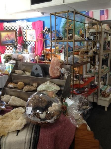 Gift shop display with rocks, crystals, and decorative items on shelves and tables