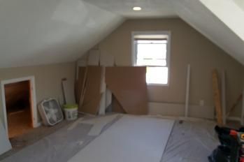 A room with a window and a fan in it