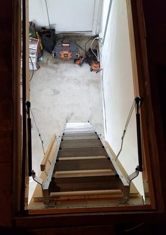 A picture of a ladder leading up to a basement.