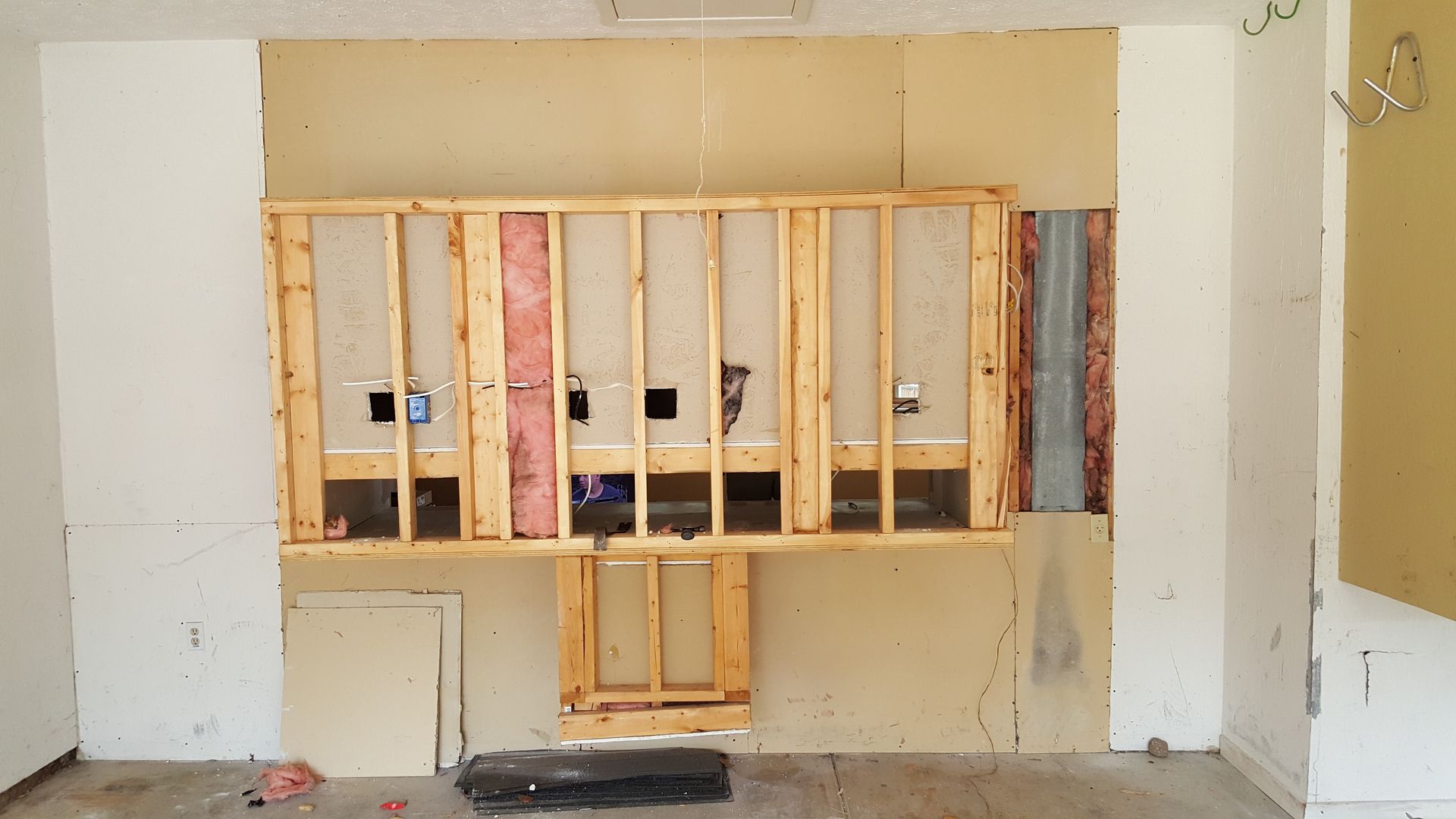 A room with a hole in the wall and a wooden frame