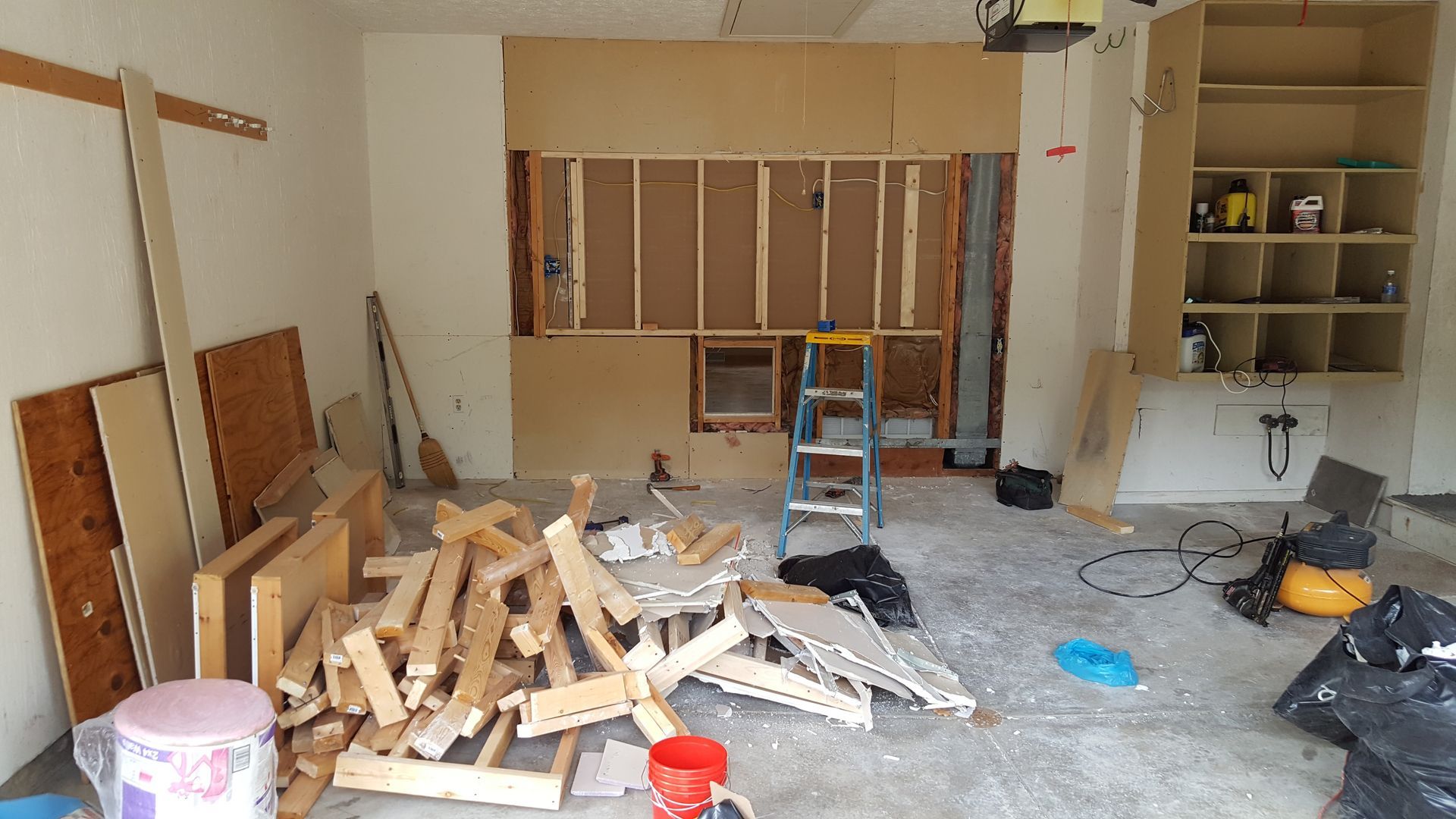 A room with a lot of wood and a ladder in it.