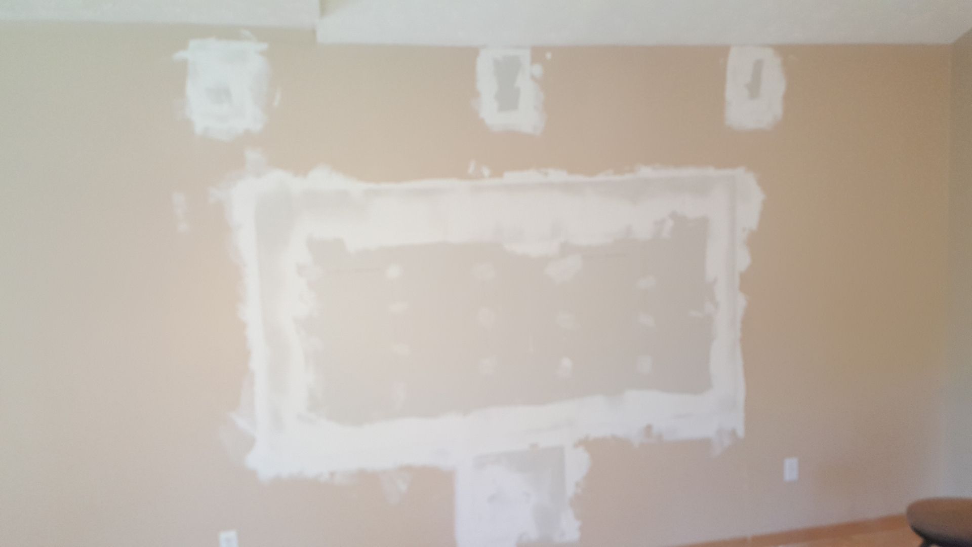 There is a hole in the wall that looks like a picture frame.