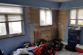 A room with a lot of stuff in it and a lot of windows.