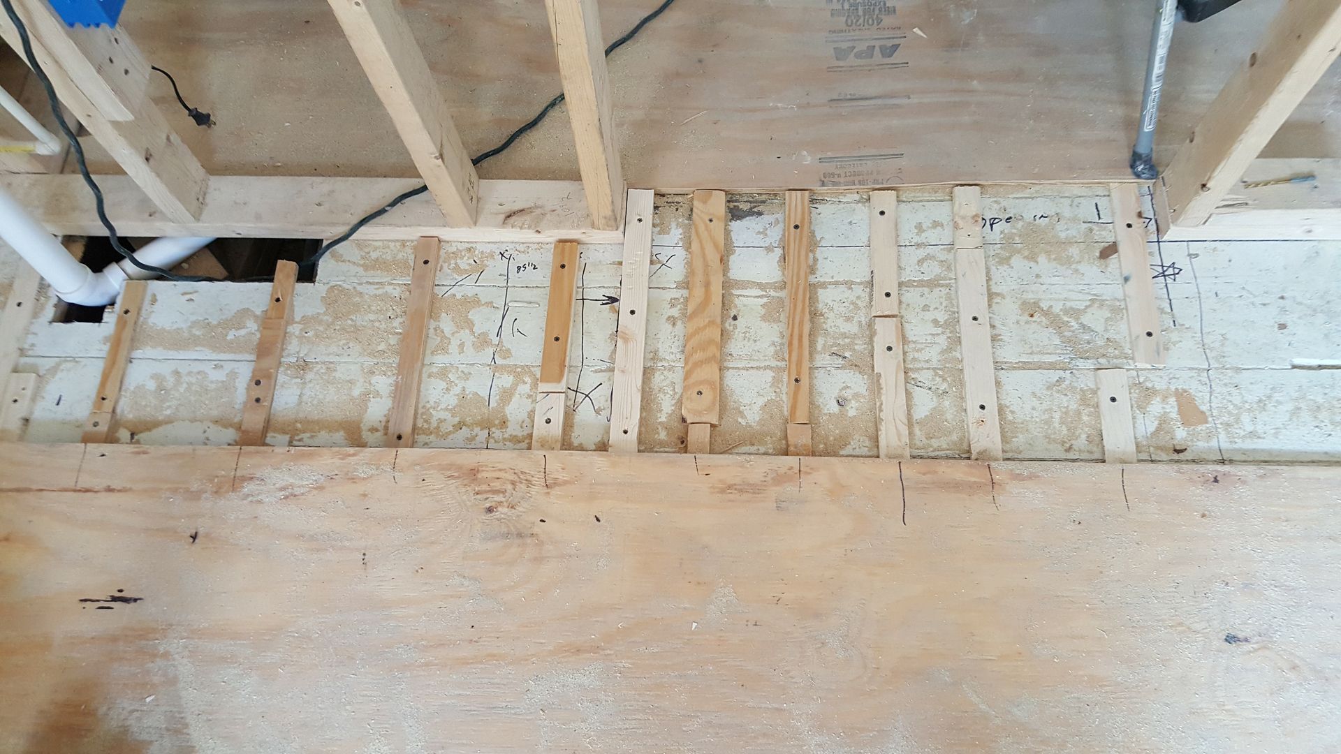 A wooden floor is being built in a house.