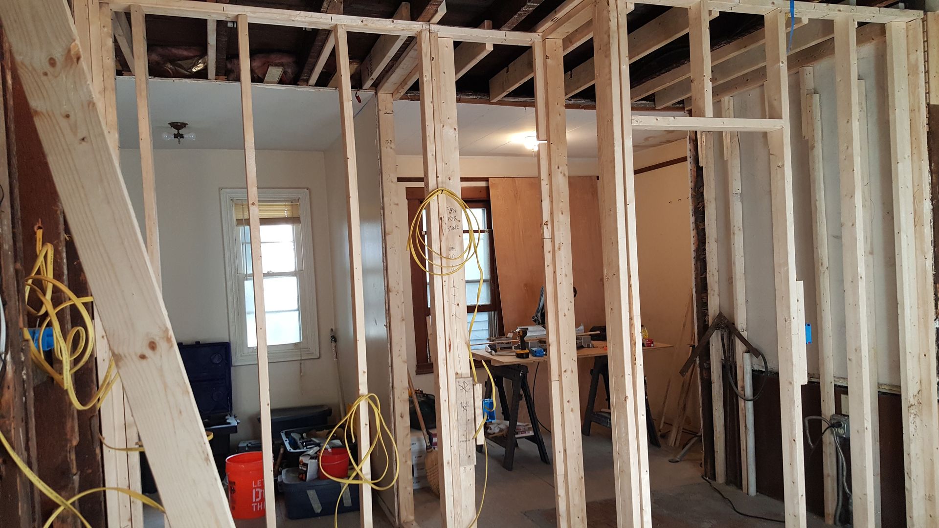 A room with a lot of wooden beams being built into it.