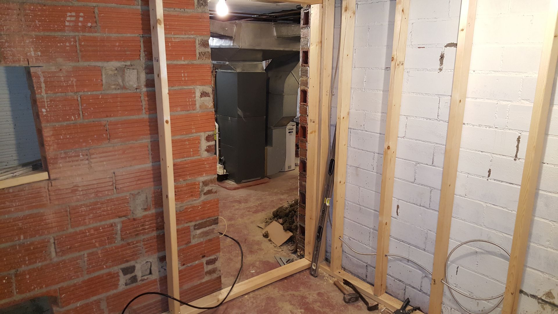 A room with a brick wall and a wooden frame.