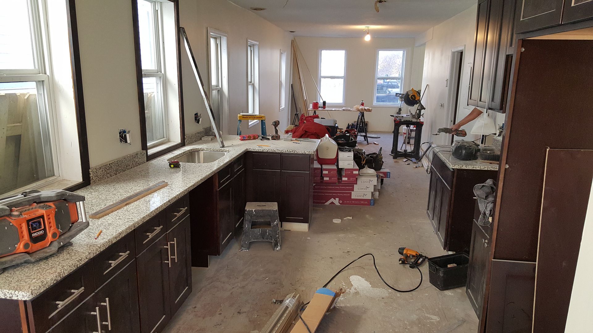 A kitchen under construction with a lot of cabinets and counter tops.