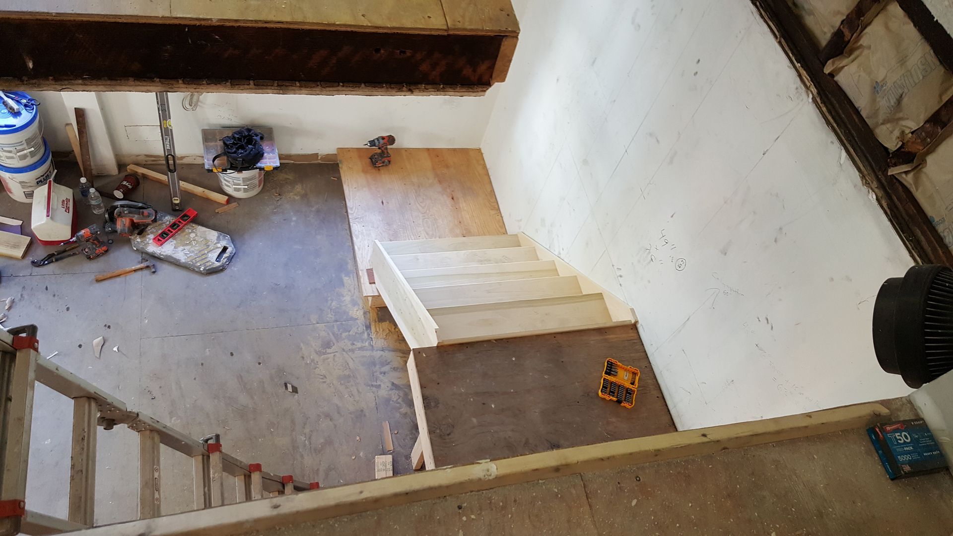 An aerial view of a staircase being built in a building.