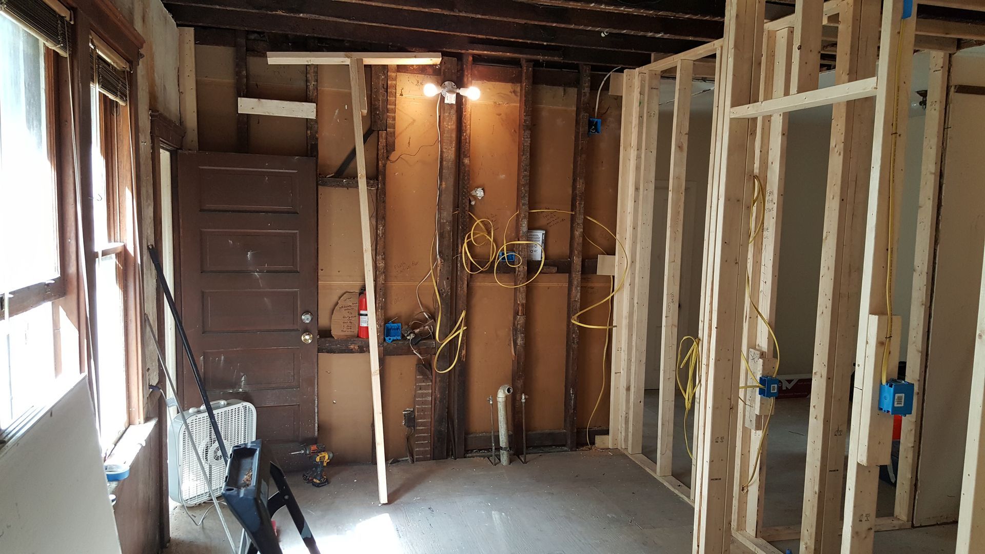 A room with a lot of wooden frames and a ladder in it.