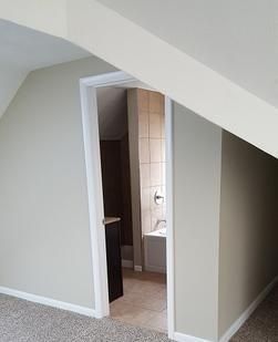 A doorway leading to a bathroom in a house.
