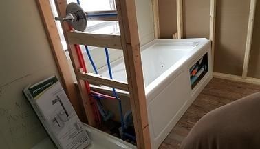 A bathtub is being built in a bathroom under construction.
