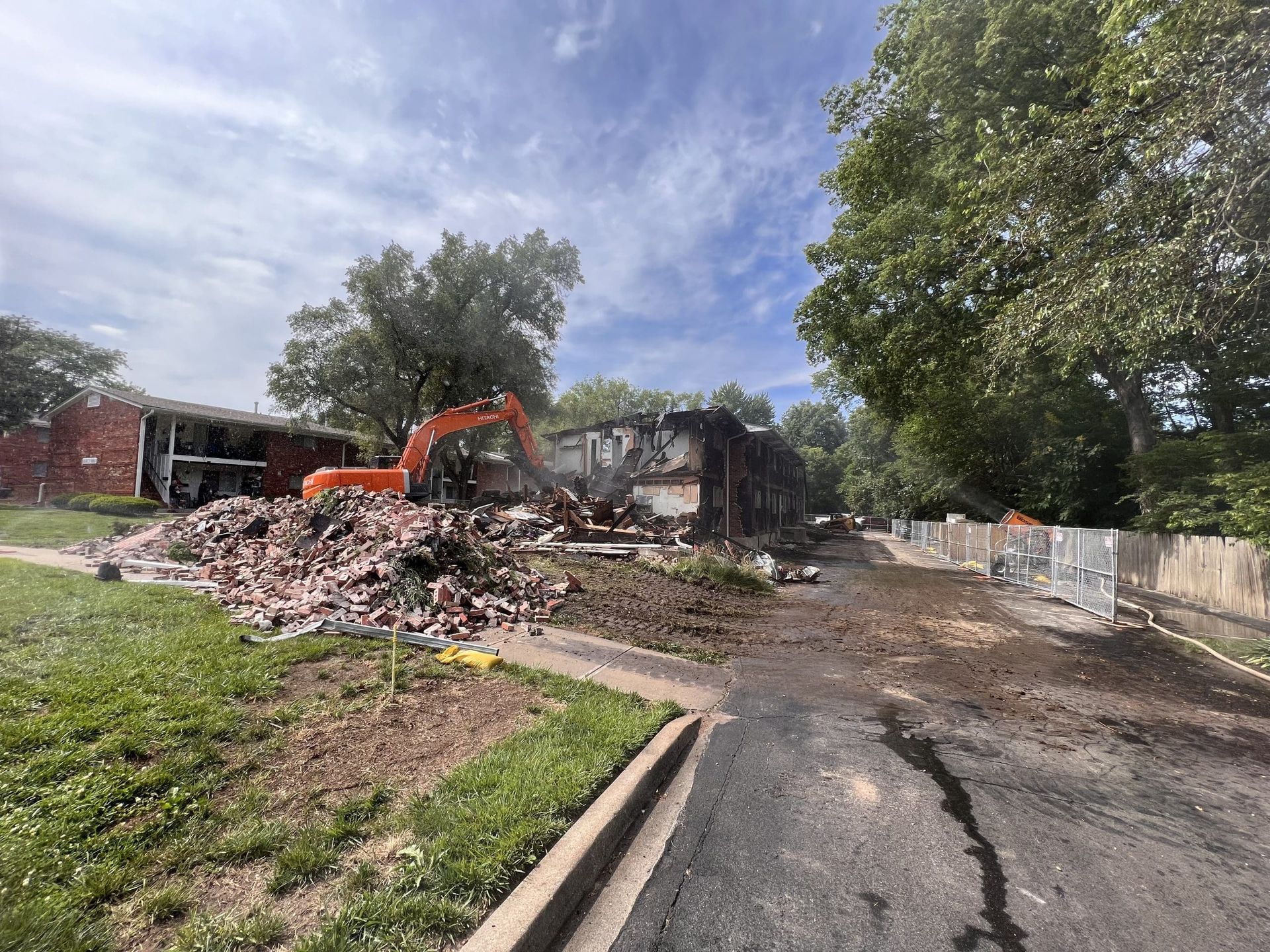 A house is being demolished in the middle of a street.