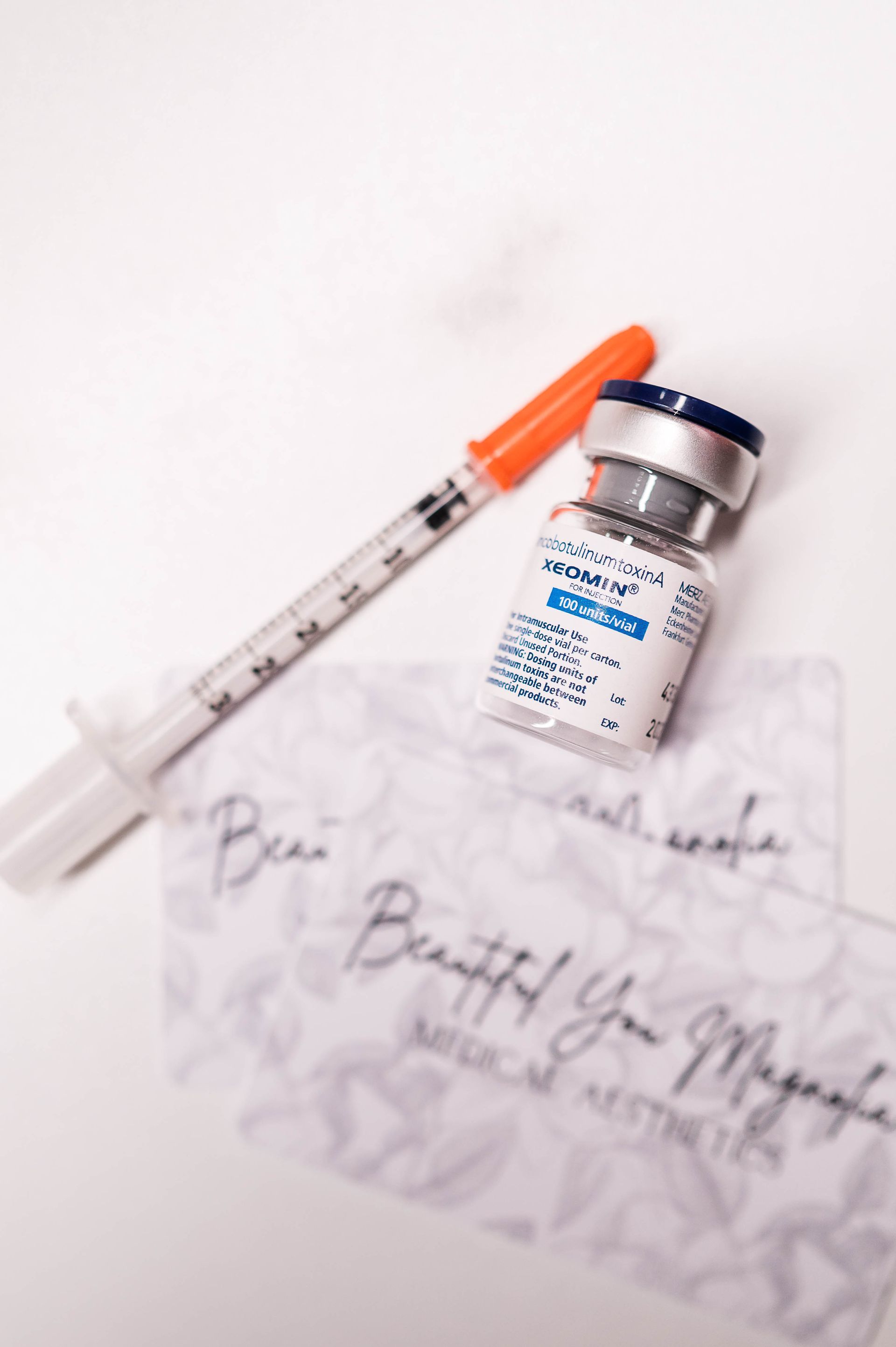 A woman is sitting in a dental chair looking at her face in a mirror.