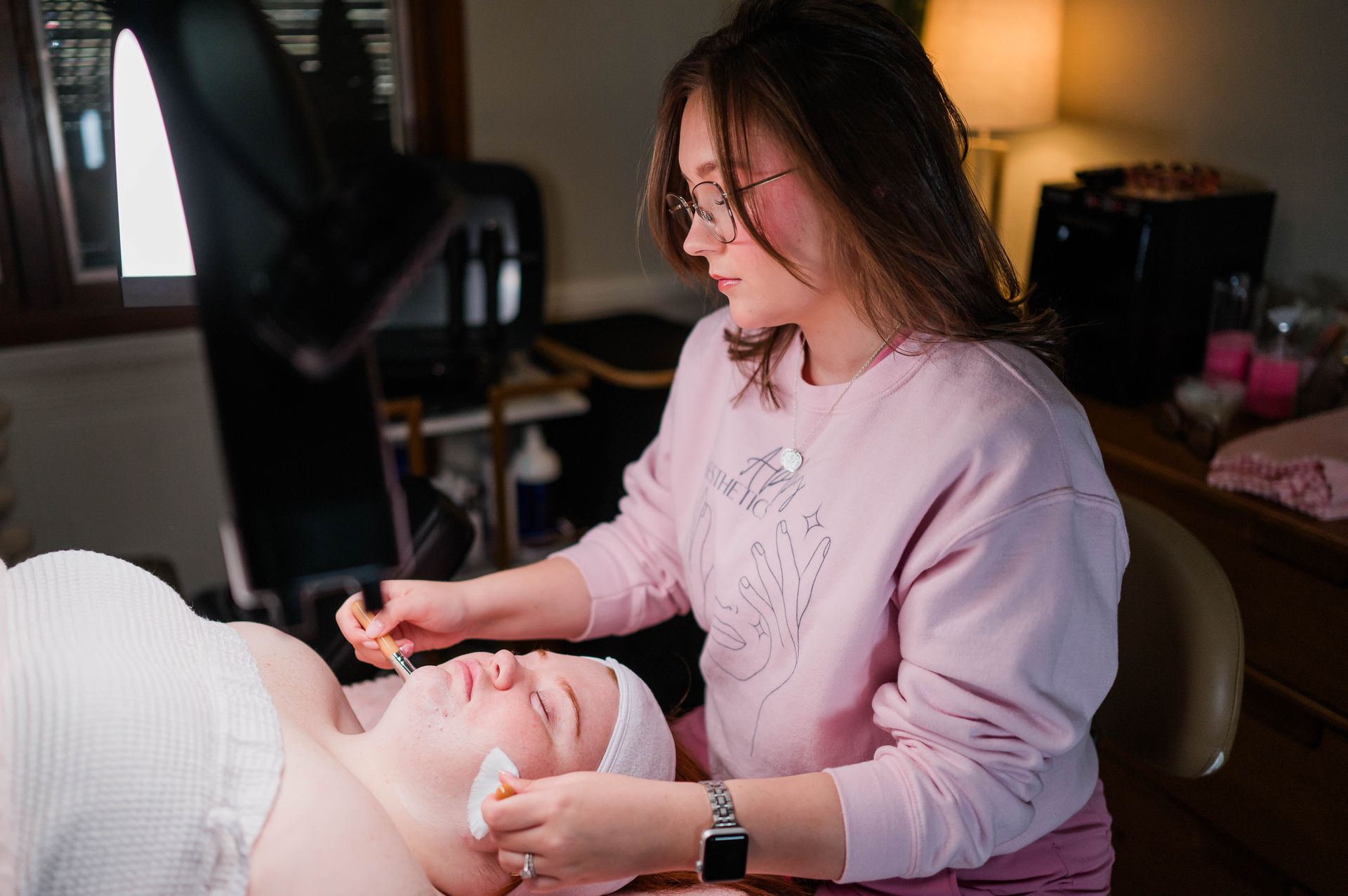 A woman is getting a head massage at a spa.