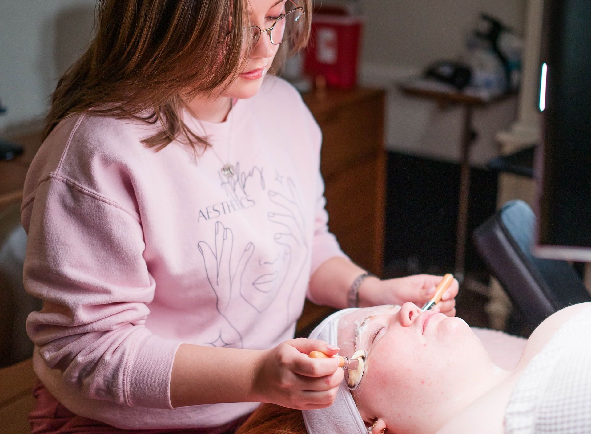 A woman is getting a facial treatment at a spa.