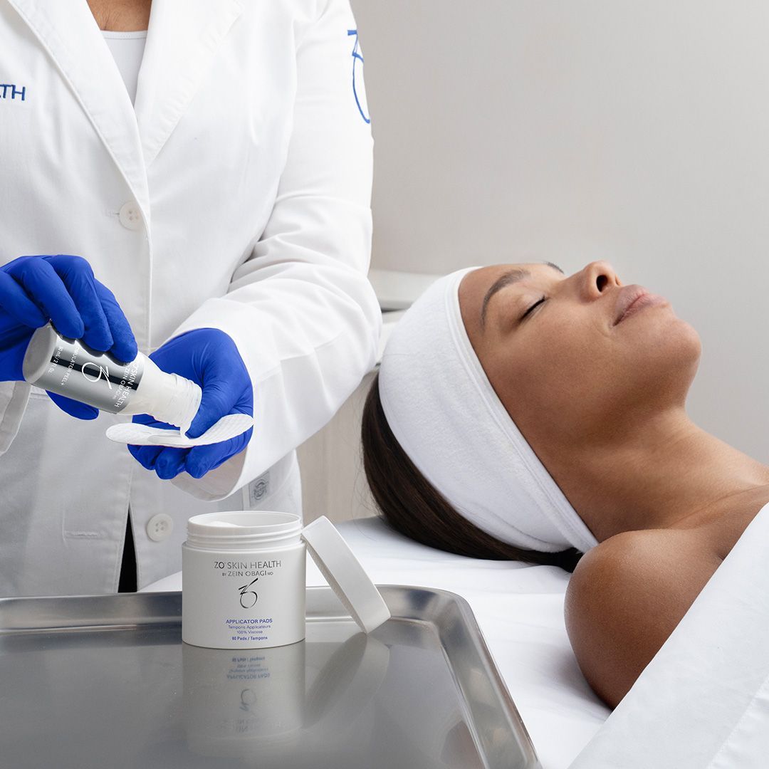 A woman laying on a bed getting a facial treatment