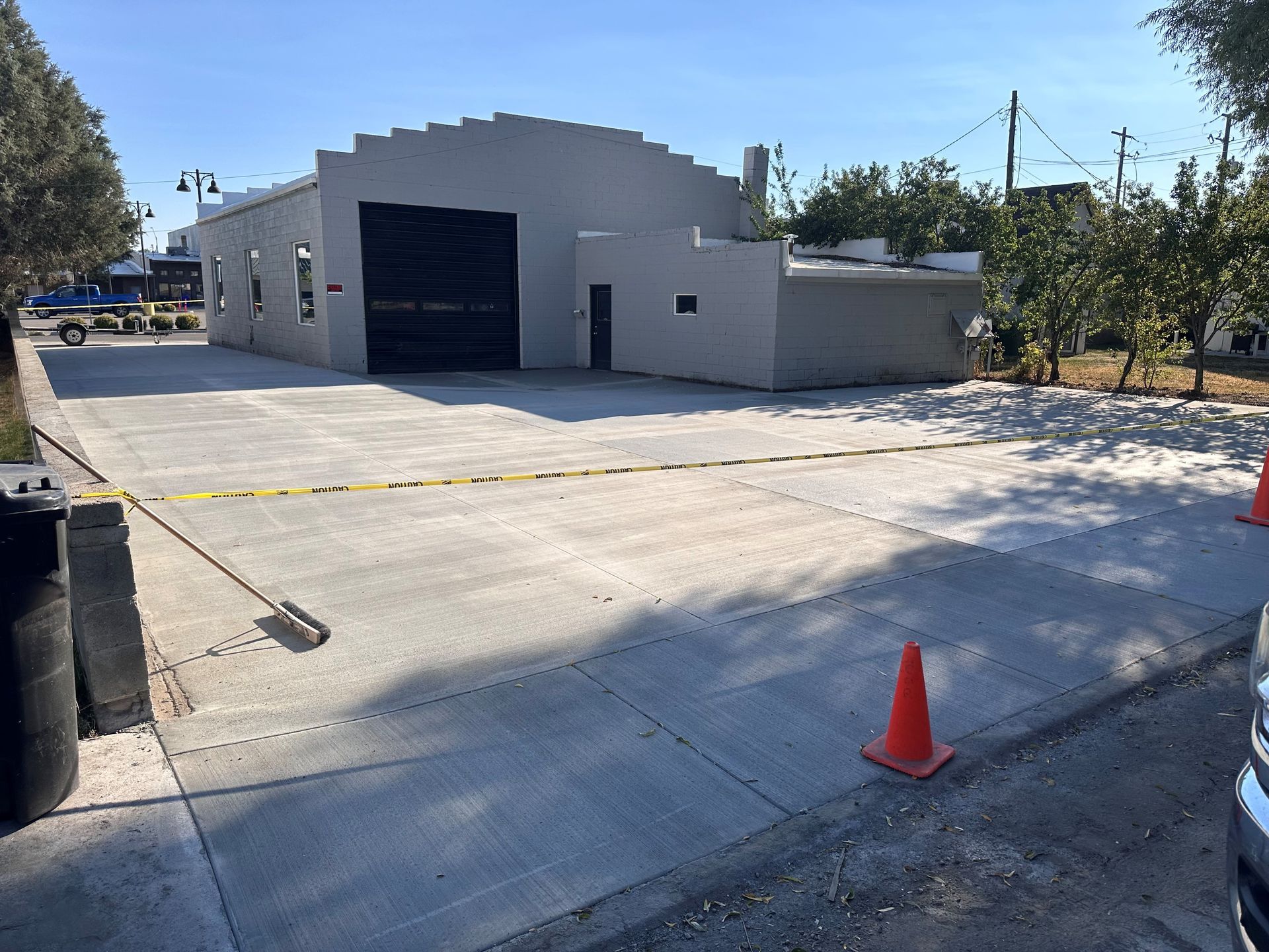 A car is parked on the side of the road in front of a building.