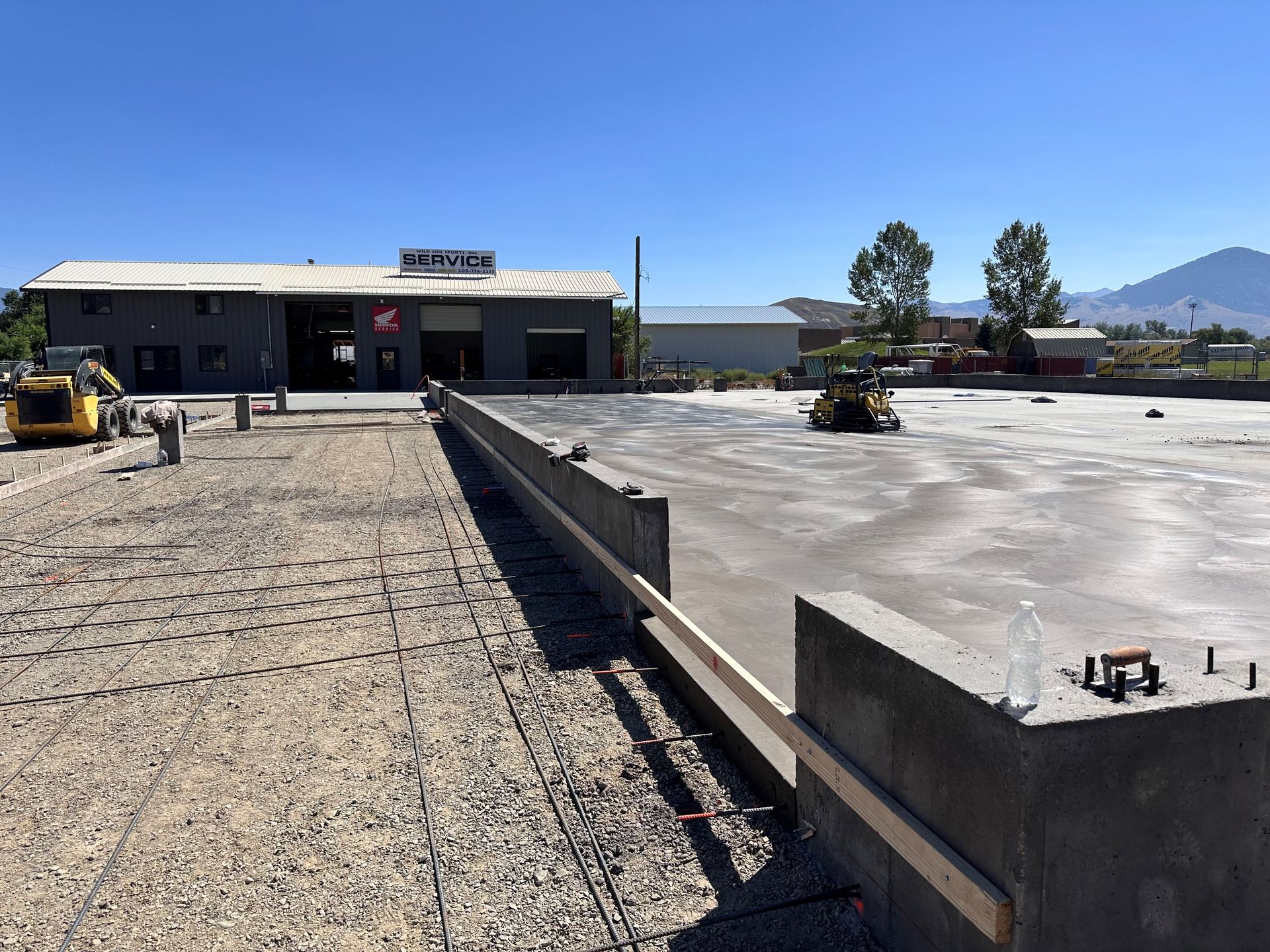 A concrete foundation being built on wide area.