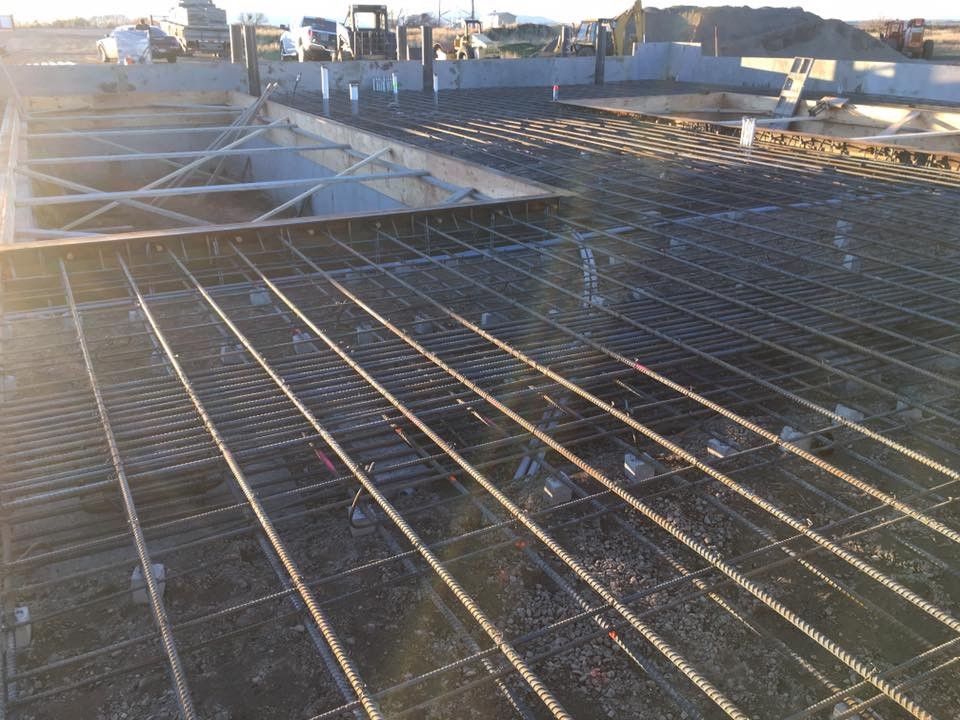 A concrete floor is being built on a construction site.