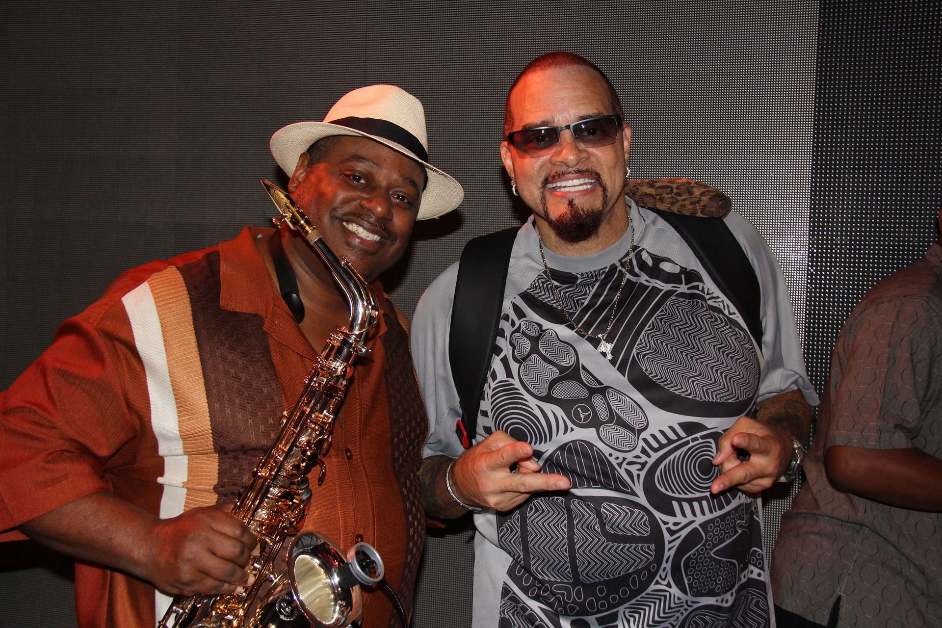 Saxophonist Deon Yates and comedian Sinbad posing for a picture