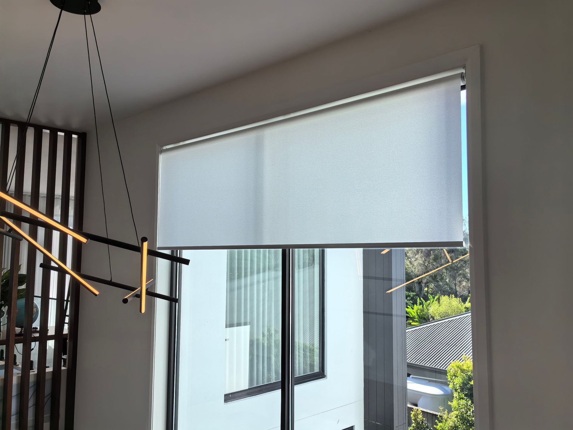 A large window with a white blind on it