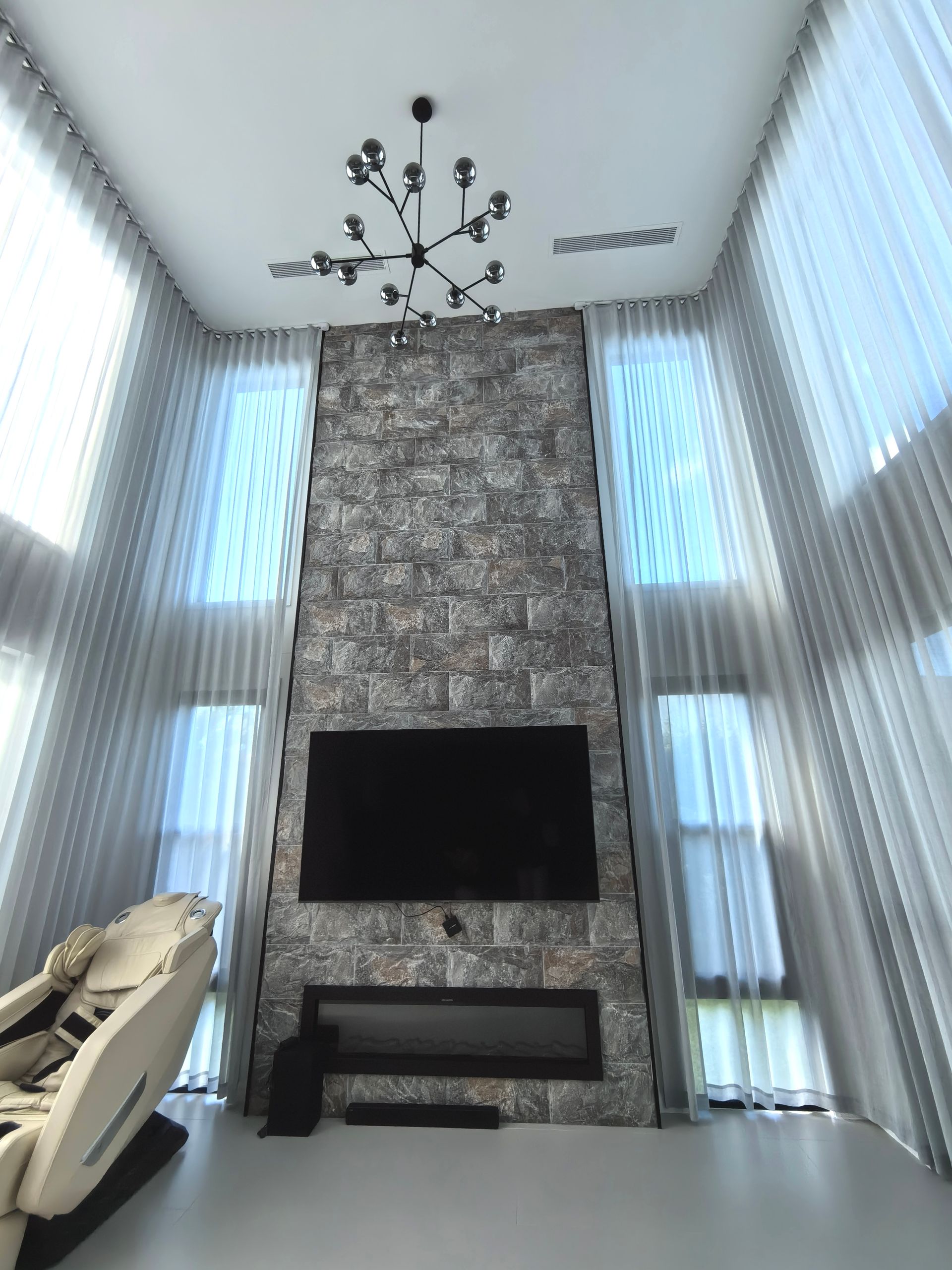 A living room with a fireplace and a flat screen tv