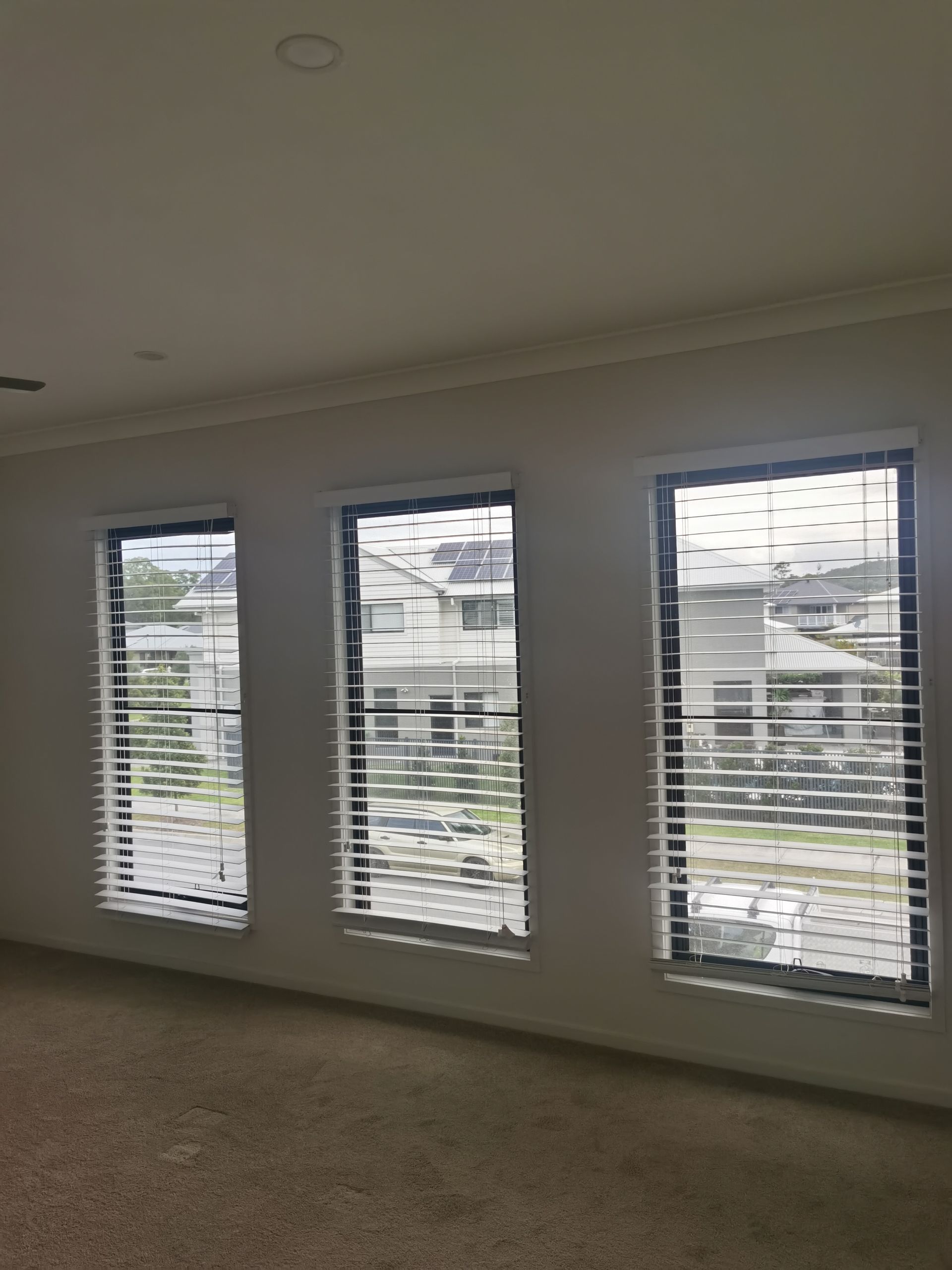 There are three windows in this room with blinds on them.